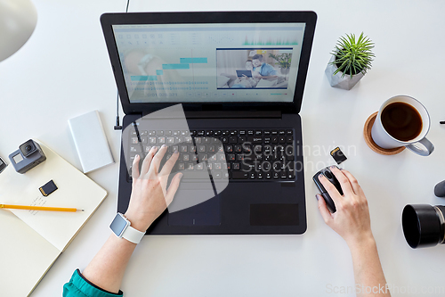 Image of woman with video editor program on laptop at home