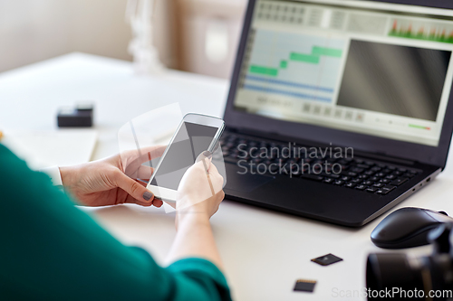 Image of woman smartphone and laptop working at home