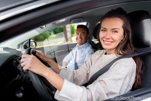 Image of car driving school instructor teaching woman