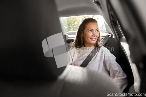 Image of happy smiling woman or female passenger in car