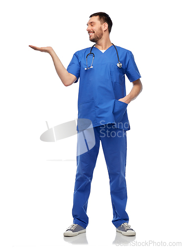 Image of smiling male doctor holding something on hand