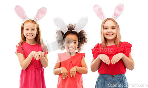 Image of happy girls wearing easter bunny ears headbands