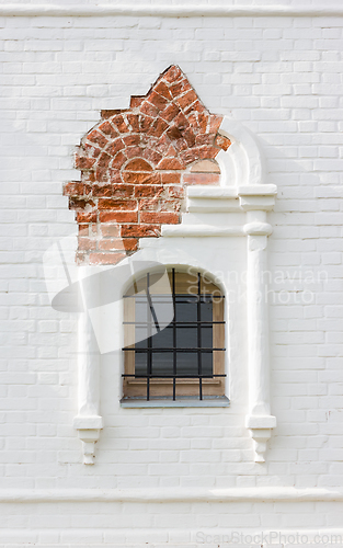 Image of Figured Window In Ancient White Brick Wall