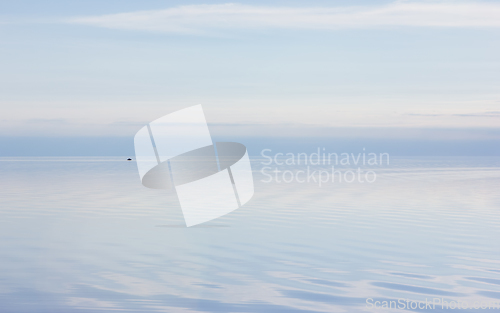 Image of Scenic View of Sea Against Sky in Tender Pastel Colors