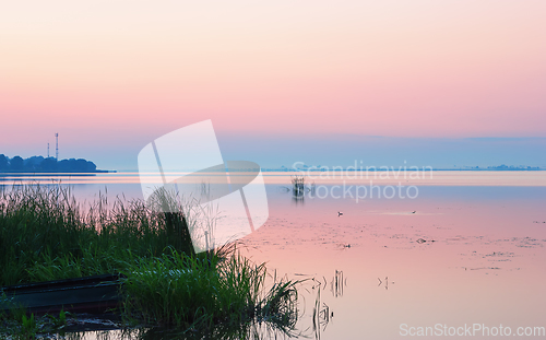 Image of Gentle Pink Dawn Over the Blue Horizon of a Calm Lake