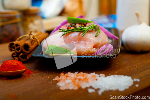 Image of fresh organic chicken breast with herbs and spices