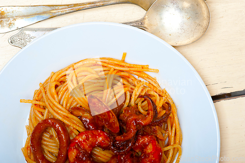 Image of Italian seafood spaghetti pasta on red tomato sauce