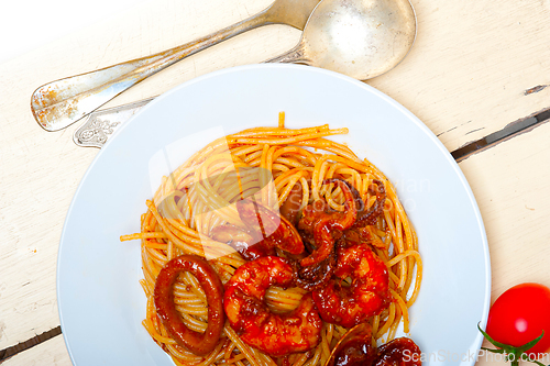 Image of Italian seafood spaghetti pasta on red tomato sauce