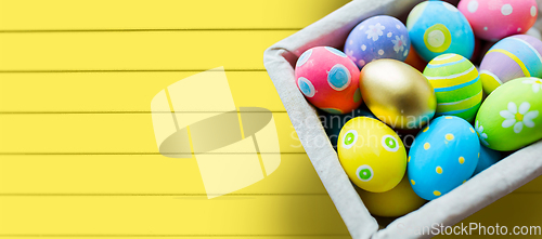 Image of close up of colored easter eggs in basket