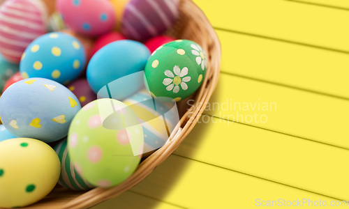 Image of close up of colored easter eggs in basket