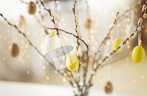 Image of close up of pussy willow decorated by easter eggs