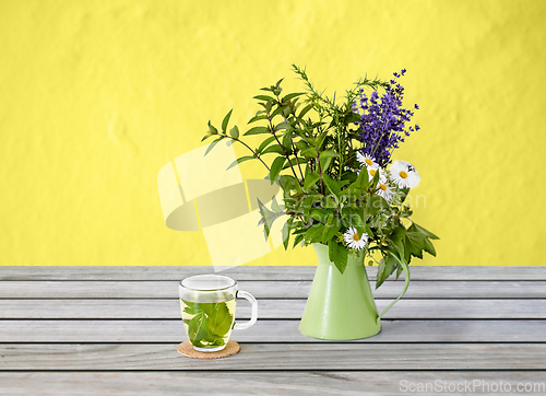 Image of herbal tea and flowers in rustic jug