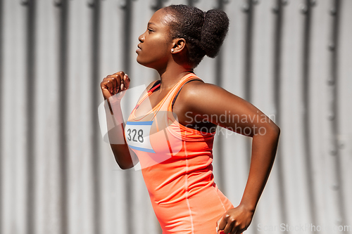 Image of young african american woman running marathon