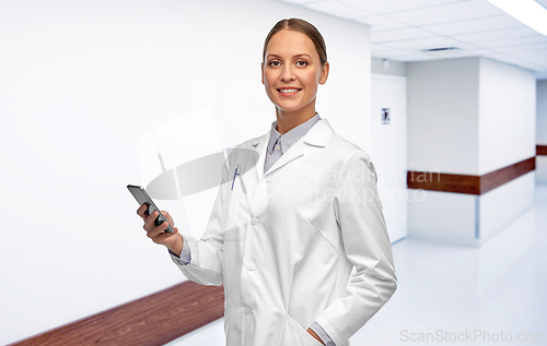 Image of happy smiling female doctor with smartphone