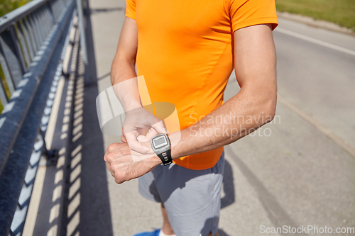 Image of close up of man with fitness tracker outdoors