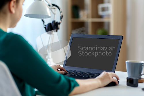 Image of woman with laptop working at home office