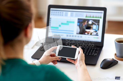 Image of woman smartphone and laptop working at home