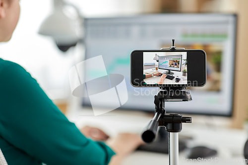 Image of smartphone recording woman working in video editor