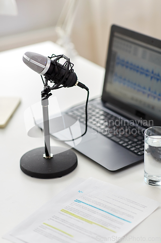 Image of microphone and sound editor on laptop at office