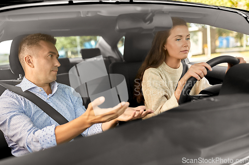 Image of car driving school instructor teaching woman