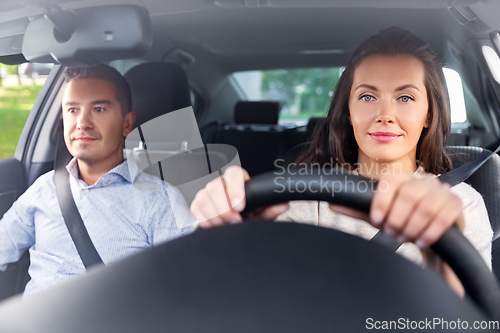 Image of car driving school instructor teaching woman