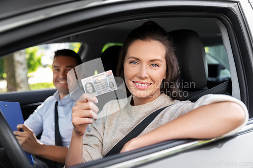 Image of car driving instructor and driver with license