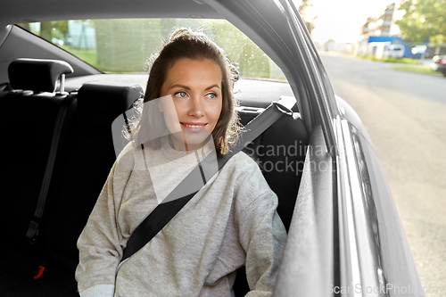 Image of happy smiling woman or female passenger in car