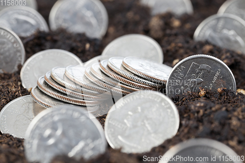 Image of coin in soil