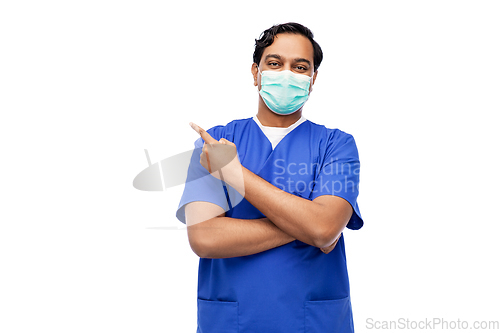 Image of indian male doctor in blue uniform and mask