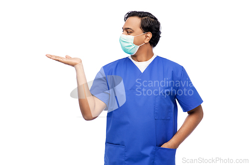 Image of indian male doctor in blue uniform and mask