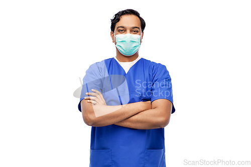 Image of indian male doctor in blue uniform and mask