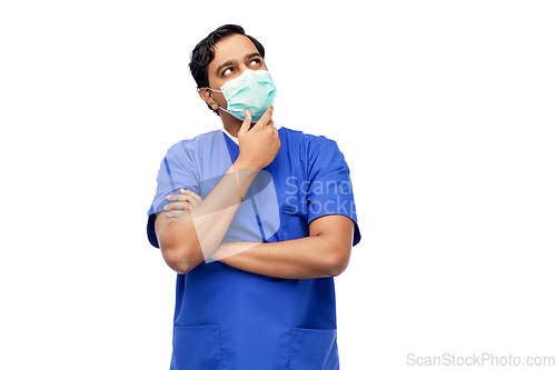 Image of indian male doctor in blue uniform and mask