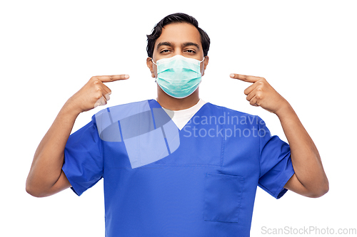 Image of indian male doctor in blue uniform showing mask