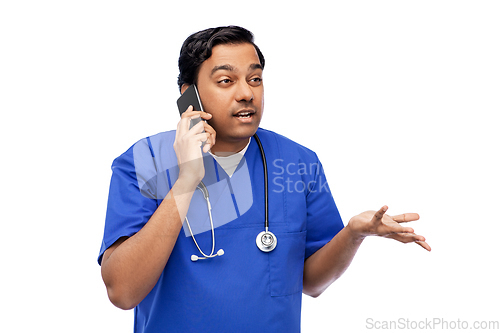 Image of indian doctor or male nurse calling on smartphone