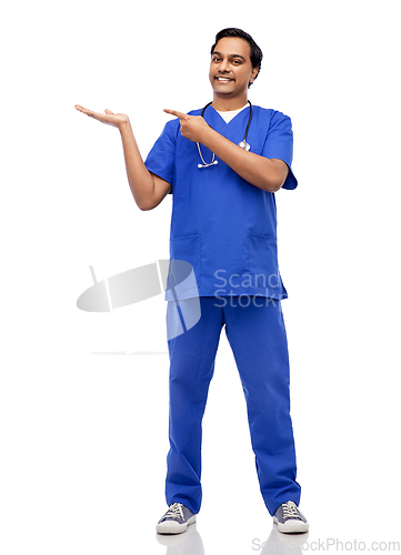 Image of happy indian male doctor holding something on hand