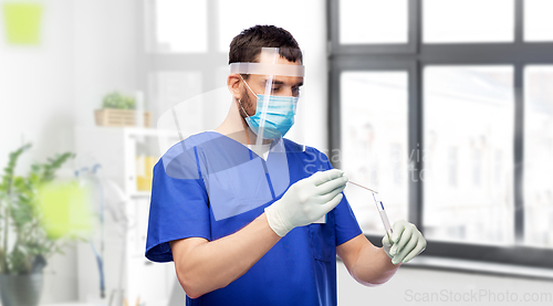 Image of male doctor in mask with cotton swab and test tube