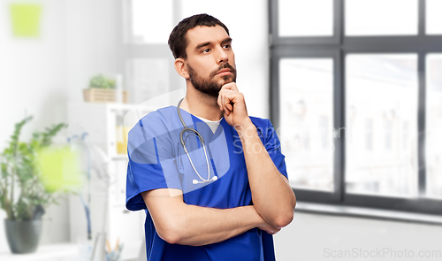 Image of thinking doctor or male nurse with stethoscope