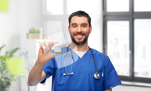 Image of doctor or male nurse with medicine and stethoscope