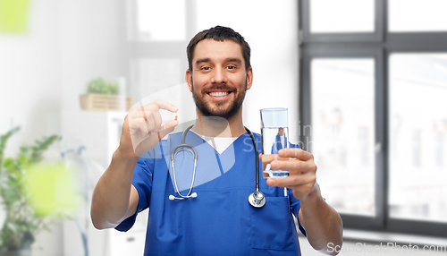 Image of doctor or male nurse with medicine and water