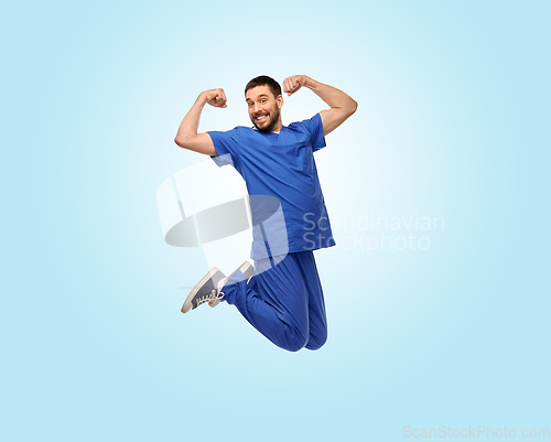 Image of happy smiling doctor or male nurse jumping in air