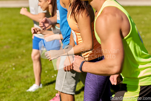 Image of sportsmen with badge numbers on start of race