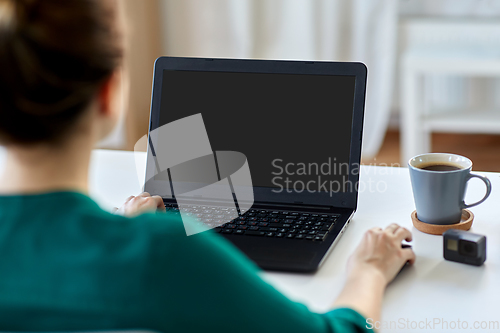 Image of woman with laptop working at home office