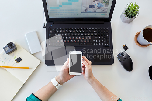 Image of woman smartphone and laptop working at home