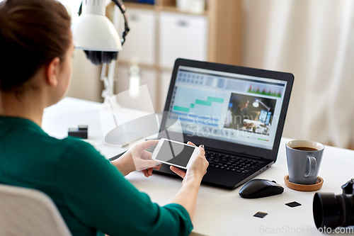 Image of woman smartphone and laptop working at home