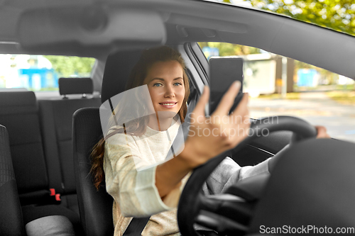 Image of woman or driver driving car and taking selfie