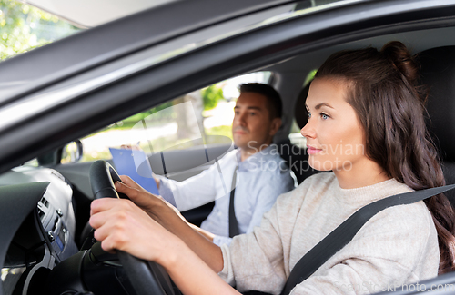 Image of car driving school instructor and young driver