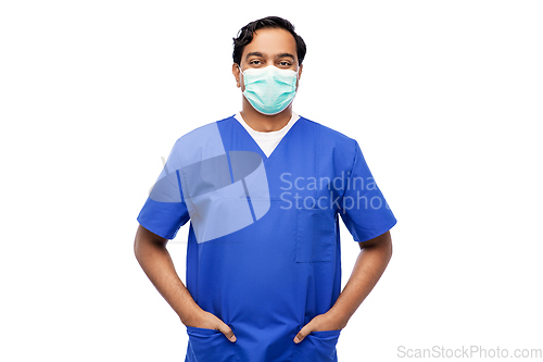 Image of indian male doctor in blue uniform and mask