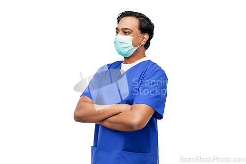 Image of indian male doctor in blue uniform and mask