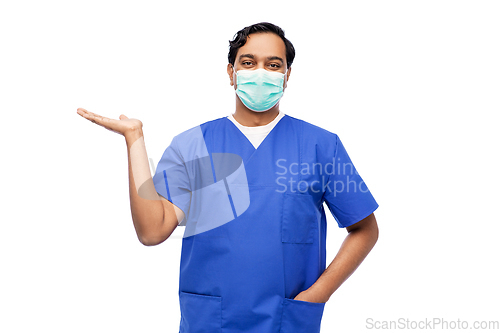 Image of indian male doctor in blue uniform and mask