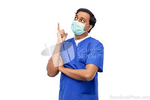 Image of indian male doctor in blue uniform and mask